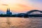 Sunset silhouette skyline landscape of the gothic Cologne Cathedra, Hohenzollern railway and pedestrian bridge, the old town and