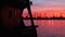 Sunset silhouettes of industrial cranes and cargo ships in Varna port, Bulgaria