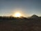 Sunset in the Sinai desert in Egypt. A large circle of sun on the horizon