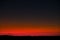 Sunset sky with bright red horizon and crescent moon
