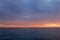 Sunset sky clouds over the Ionian Sea in Apulia, Italy.