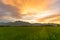Sunset sky on field.Beautiful sunset sky with dramatic light over mountain.rural landscape background