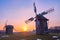 The sunset sky over the hill with timber windmills, Polissya Region architecture, Pyrohiv Skansen, Kyiv, Ukraine