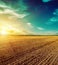 Sunset sky over plowed field