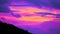 Sunset sky with purple cloud move pass green top silhouette mountain