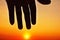 Sunset sky and silhouette hand icon