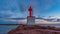 Sunset sky timelapse in marina entrance with lighthouse