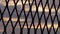Sunset sky through view of fence in silhouette