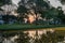 Sunset sky and yellow petals of Padauk flowers covering the pond at Phutthamonthon public park,Nakhon Pathom Province,Thailand.