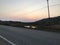 Sunset Splendor: Endless Road, Blue Sky, and Orange Hues