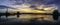 Sunset steam pump station with reflection in water