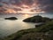 Sunset at Strumble Head Lighthouse with orange clouds, Pembrokeshire, Wales