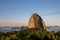 Sunset at Sugarloaf mountain with forests in foreground and mountains in background in Rio de Janeiro, Brazil, South America