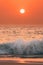 Sunset Sun Above Sea. Natural Sunrise Sky Warm Colors Over Ripple Sea. Ocean Water Foam Splash Washing Sandy Beach At
