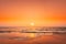 Sunset Sun Above Sea. Natural Sunrise Sky Warm Colors Over Ripple Sea. Ocean Water Foam Washing Sandy Beach At Sunset