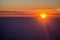 Sunset or sunrise from an airplane peeking through the clouds