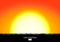 Sunset or sunrise background with black grass silhouette. Burning sun sets over the horizon. Evening dawning background