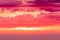 The sunset or sunrise. The cloudy sky cloured in red, orange, rose, scarlet, crimson, purple, violet and blue colores