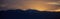 Sunset/sunrise over dark mountains silhouettes