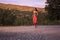 sunset sunrise, wood trees, running jogging, one young adult woman, sportswear sport clothes, outdoors, pavement road