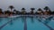 Sunset swimming pool at low season resort. Beautiful panorama of open air pool.