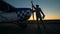 Sunset take-off runway with a male service engineer cleaning the airplane