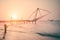 Sunset at tropical beach. Ocean coast landscape with chinese fishing nets silhouette at Cochin Kochi. South India, Kerala,