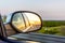 Sunset through Truck Rear view Mirror On highway