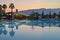 Sunset in Turkey. Swimming pool, palm trees, mountains.