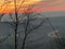 Sunset on Uetliberg in Zurich Switzerland. Busy highway with lights seen.The red orange color of sky contrasts with blue mountains