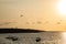 Sunset view of the beach with a plane silhouette taking off