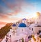 Sunset view of the blue dome churches of Santorini, Greece.