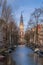 Sunset view of the famous historic center with lights, bridges, canals and traditional Dutch houses in Amsterdam, Netherlands