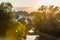 Sunset view flying midges over British rural landscape scene with river near Northampton