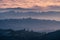 Sunset view of layered hills and valleys covered by a sea of clouds in Santa Cruz mountains ; San Francisco bay area, California