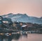 Sunset view of Maniitsoq arctic city in Greenland. Mountains in background during midnight sun. Colourfull houses and