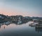 Sunset view of Maniitsoq arctic city in Greenland. Mountains in background during midnight sun. Colourfull houses and