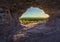 Sunset view through the rock. Arenite eroded by action of wind over time.