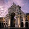 Sunset view of Rua Augusta Arch lit up.