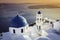 Sunset view of Santorini blue dome churches