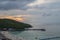 Sunset view of tawean beach with crowded of tourist on the beach in cloudy day.