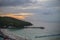 Sunset view of tawean beach with crowded of tourist on the beach in cloudy day.