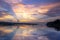 Sunset view of the Victoria Nile river, with trees growing and the reflections on the water, Jinja, Uganda