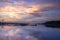 Sunset view of the Victoria Nile river, with trees growing and the reflections on the water, Jinja, Uganda