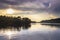 Sunset view of the Victoria Nile river, with trees growing and the reflections on the water, Jinja, Uganda