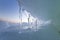 Sunset view on the winter seacoast with the stacks and piles of the ice formations