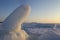 Sunset view on the winter seacoast with the stacks and piles of the ice formations