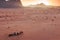 Sunset in the Wadi Rum desert, Jordan, with local bedouins and camels on foreground