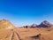 Sunset in Wadi Rum desert. Sundown and rocky mountains. Safari ride on pick up trucks.