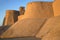 Sunset at the walls of the ancient fortress of Kunya Ark. Khiva, Ichan-Kala